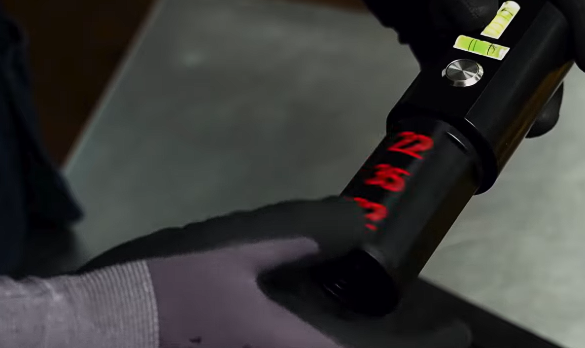 Red laser digits projected from the TRUEPOINT head onto a dark surface